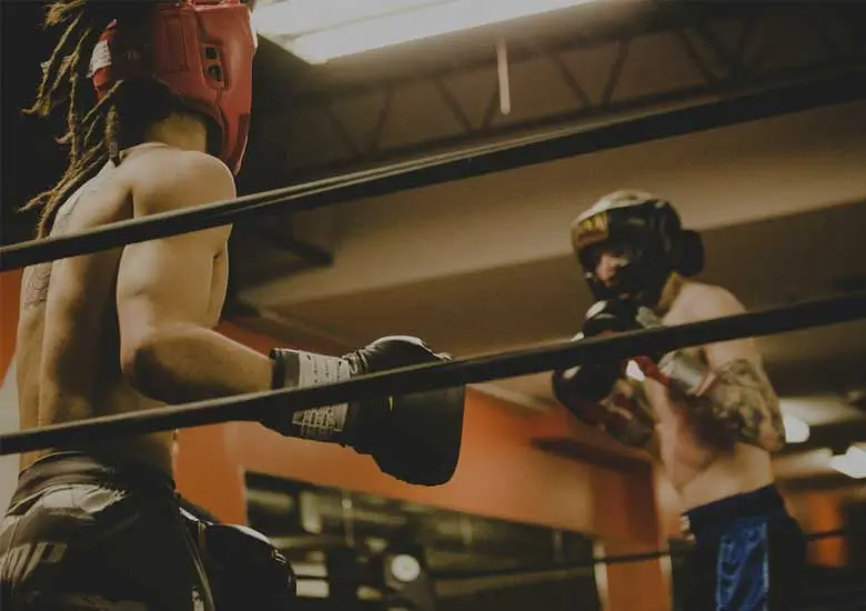 Two men in a boxing ring, fighting